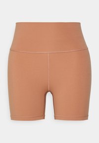 Cuissards de biker marron taille haute sans coutures avec surpiqûres plates visibles le long de la ceinture et des ouvertures des jambes.