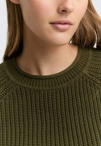 Zielony wełniany sweter o teksturowanym, prążkowanym wzorze, okrągłym dekolcie i rękawach raglanowych, charakteryzujący się miękkim materiałem i gęsto tkanym wzorem.