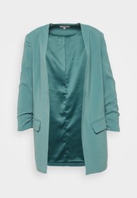 Turquoise blazer met een open voorkant, lange mouwen en twee voorkeurszakken. Heeft een gladde satijnen textuur en een ontspannen pasvorm.