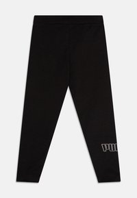 Leggings negros hechos de una tela suave y elástica. Presentan un logo en un color contrastante en la parte inferior de la pierna. Diseño ajustado y ceñido.