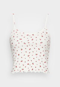 Top cropped branco com nervuras e alças finas, apresentando um padrão de flores vermelhas dispersas e bainha ondulada. Feito de um tecido macio e elástico.