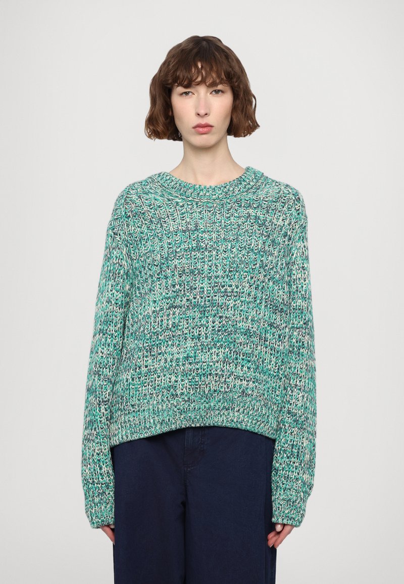 Turquoise knit sweater with a loose fit, wide ribbed texture, and a round neckline. Long sleeves with a slightly cropped hem.