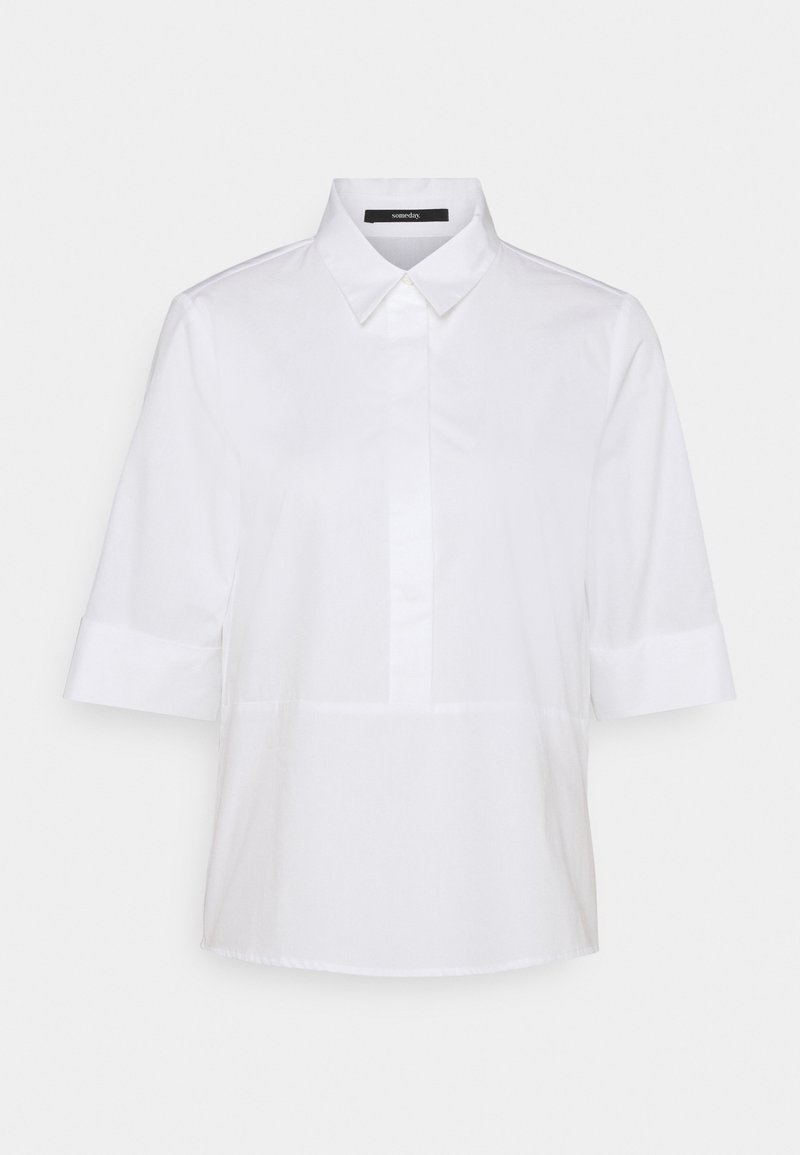 Camicia bianca a maniche corte con colletto, chiusura frontale a bottoni e design senza cuciture. Tessuto liscio dallo stile semplice e minimalista.