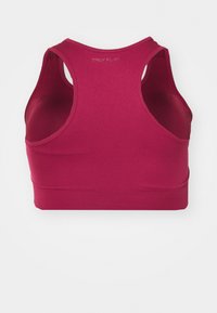 Mauve sporta krūšturis ar racerback dizainu, izgatavots no elastīga auduma, ar plašu apakšmalu un minimālu šuvju skaitu, lai nodrošinātu komfortu.