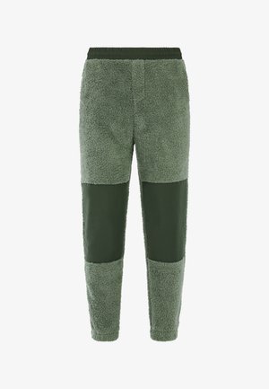Fleece joggingbroek in olijfgroen met een getextureerde, pluizige afwerking. Beschikt over gladde, bijpassende accenten op de benen en een elastische tailleband.