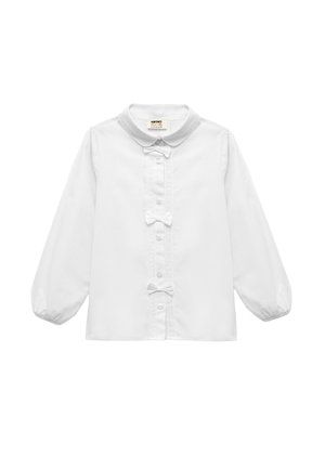 Chemise blanche à manches longues avec un col rond, fermeture à boutons sur le devant, détails en dentelle et deux petits nœuds au centre. Tissu à texture lisse.