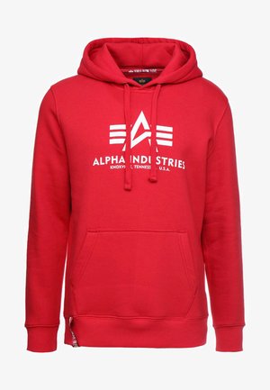 Piros kapucnis felső, elülső kenguruzsebbel, húzózsinórral és fehér "Alpha Industries" logóval, vízszintes csíkokkal. Pamut keverék anyag.