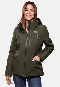 Woman smiling wearing an olive green Marikoo Mountain zip-up jacket with hood, black zipper details, and blue jeans, hand in pocket.