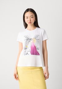 White cotton T-shirt featuring an illustrated design of a figure in a pink dress, set against a cityscape backdrop. Short sleeves, relaxed fit.