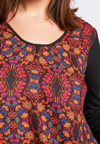 Black top featuring a floral pattern in orange, blue, and purple. Curved neckline with gathered detail, and long black sleeves.