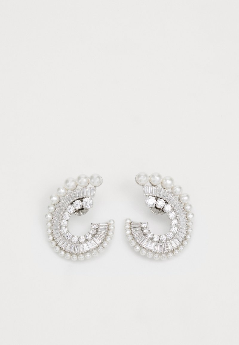 Silver-tone earrings featuring a curved design, adorned with pearls and clear rhinestones in various cuts, adding texture and detail.