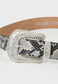 Ceinture au motif serpent noir et blanc avec une boucle ornée en argent décorée de strass, dotée d'une doublure intérieure lisse couleur tan.