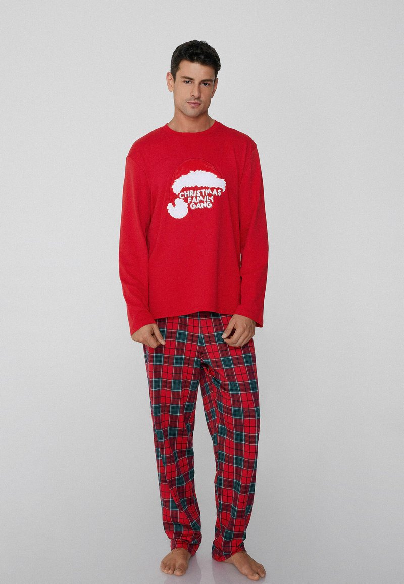 Camisa roja de manga larga con texto blanco 'Christmas Family Gang' y un gráfico de gorro de Santa, combinada con pantalones de cuadros rojos con detalles en verde.