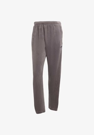 Pantalons de survêtement gris en matériau doux, avec une taille élastique et un accent logo sur le côté. Design à jambe droite, sans détails supplémentaires.