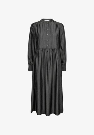 Fekete, hosszú ujjú ruha magas nyakkal, gombos elülső zárással, gyűrt derékrésszel és kis fehér pöttyökkel. Simogatón puha anyag, amely folyékony siluettet ad.