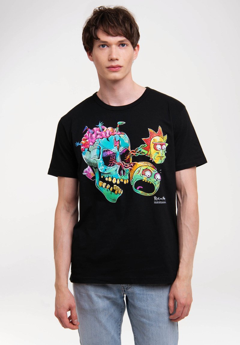 Black cotton T-shirt featuring a colorful graphic design of a skull with cartoon elements and characters, in a relaxed fit on a male model.