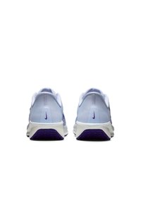 Zapatillas deportivas en morado y azul claro con parte superior de malla, suela acolchada y suela blanca prominente. El logo se muestra en el talón.