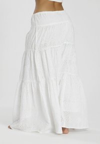 Gonna maxi bianca con intricate sagome a occhio, strati a balze, vita elasticizzata e tessuto leggero e testurizzato.