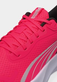 Φωτεινό ροζ παπούτσι τρεξίματος Puma με επάνω μέρος από δίχτυ, ροζ κορδόνια, ανακλαστική ασημένια ρίγα και μαλακή λευκή σόλα.