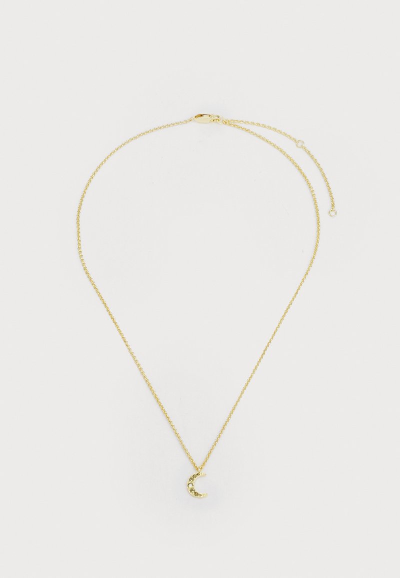 Kuldtooni kaelakee, millel on õrn kett ja poolkuu ripats, mille kurvis on väikesed kalliskivid. Reguleeritav pikkus koos klambriga.