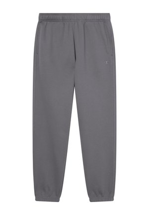Graue Jogginghose aus weichem Material, mit elastischem Bund, seitlichen Taschen und elastischen Bündchen an den Knöcheln. Logo an der unteren linken Wade.