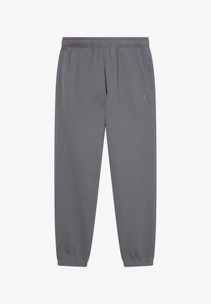 Graue Jogginghose aus weichem Material, mit elastischem Bund, seitlichen Taschen und elastischen Bündchen an den Knöcheln. Logo an der unteren linken Wade.