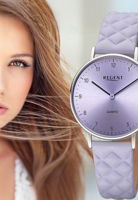Quartz watch with a round, lavender gradient dial, silver hands, and a textured lavender leather strap featuring a quilted pattern.