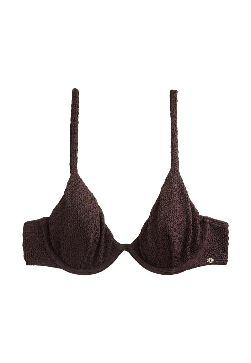 Sutien din material texturat maro închis, cu bretele subțiri reglabile și suport cu armătură, având un mic logo metalic al mărcii pe banda laterală.