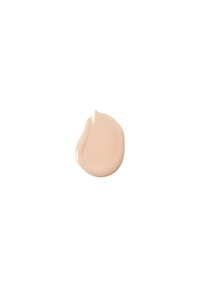 Beige nestevoima, med en jevn, kremaktig tekstur, som danner en dråpe på en hvit bakgrunn.