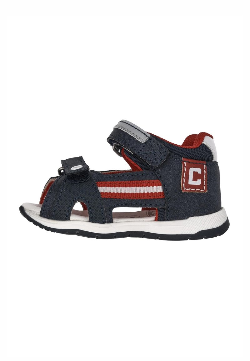 Sandali in tessuto blu navy e rossi con cinturini in velcro, design open-toe e suola in gomma bianca con pattern di trazione neri.