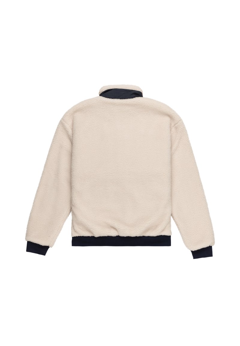 Chaqueta de forro polar en crema con cuello alto y puños y el dobladillo en azul marino. Presenta una superficie suave y texturizada y un corte relajado.