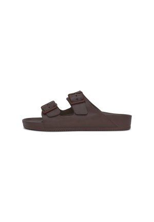 Sandali infradito marroni in gomma con due cinturini regolabili, una soletta testurizzata e una suola piatta per il massimo comfort. Finitura liscia, design minimalista.