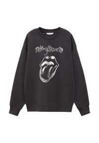 Svart sweatshirt i bomull, med en vit Rolling Stones-logotyp med grafik av läppar och tunga på framsidan. Rund hals och långa ärmar.