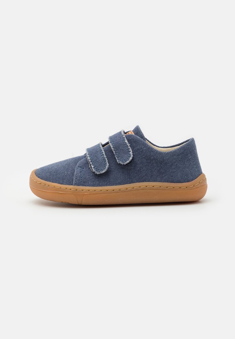 Blue fabric shoe with two adjustable Velcro straps, round toe, beige rubber sole, and stitched detailing along the edges.