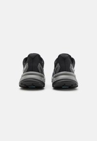 Black athletic shoes featuring a mesh upper, gray accents, padded collar, and a textured sole for enhanced grip and support.