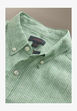 Rohelise ja valge triibuline nööbitav särk, voltidega kraega ja valgete nööpidega, kus on nähtav brändi silt ja keskmise suuruse silt.