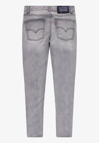 Grå jeans med slank passform, mid-rise midje, klassisk femlommersdesign og dobbeltsydde sømmer for holdbarhet.