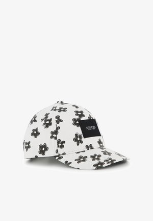 Casquette snapback en tissu blanc avec un motif floral noir. Présente un patch logo noir à l'avant. Design structuré avec une visière incurvée.