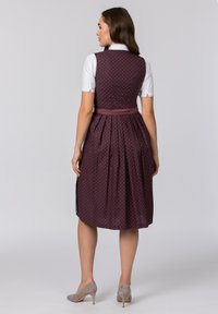 Mauve dress with white polka dots, fitted bodice, flared skirt, and a waistband. Short-sleeved white blouse with lace trim at cuffs.
