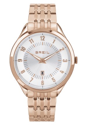 Rožnato zlato ura z srebrnim teksturiranim številčnicom, arabske številke, prikaz datuma in povezan kovinski pas. Ime blagovne znamke "BREIL" je izpostavljeno.