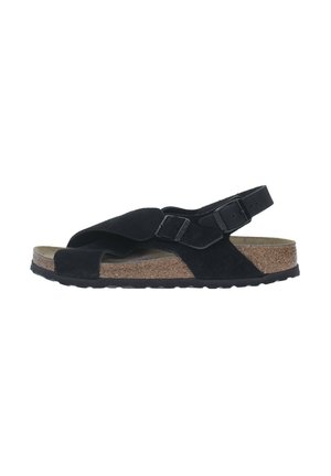 Sandales en suède noir avec une conception à brides croisées, sangle de talon ajustable, semelle en liège et semelle en caoutchouc texturé.