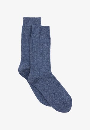 Tummansinisiä ribbineule sukkia, joissa on pehmeä rakenne, yksivärinen ilme ja klassinen sukkamuoto, viimeistelty mukavalla resorilla.