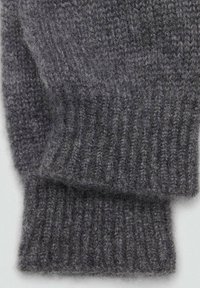Gray knitted sweater cuff with ribbed texture, featuring thick yarn with a soft, fuzzy appearance. Simple and functional design.