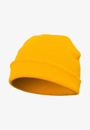 Sárga kötött sapka hajtott szegéllyel. Puha, rugalmas anyagból készült, bordázott textúrával, amely melegséget és kényelmet biztosít.