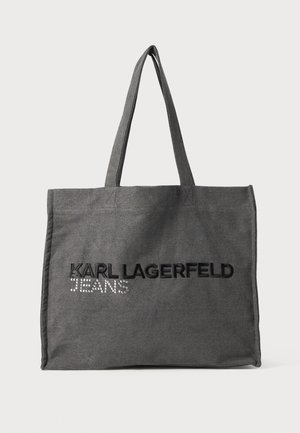 Gray tote bag made of fabric, featuring black embroidered text "KARL LAGERFELD" and "JEANS" with rhinestone accents. Two shoulder straps.