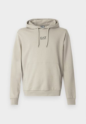 Light beige hoodie with drawstring, kangaroo pocket, and EA7 logo on the chest. The fabric appears soft with a smooth texture.