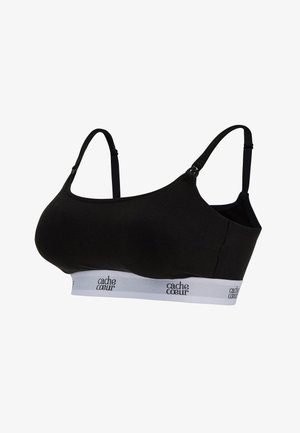 Zwarte geribbelde bralette met verstelbare banden en een witte elastische band met het "cache coeur"-logo. Gladde textuur, eenvoudig ontwerp.