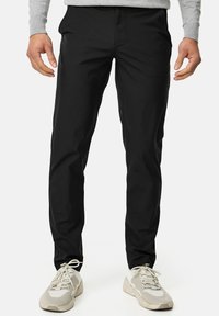 Schwarze, maßgeschneiderte Hose aus leichtem Material mit glatter Textur und klassischem Design. Mit Taschen vorne und geradem Bein.