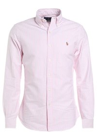 Ljusrosa skjorta med knappar och vita ränder, långa ärmar och krage. Har en liten broderad logotyp på vänster bröst.