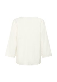 Haut blanc léger en lin avec une coupe décontractée, doté de manches trois-quarts et d'un col rond. Pas de fermetures ni de motifs visibles.